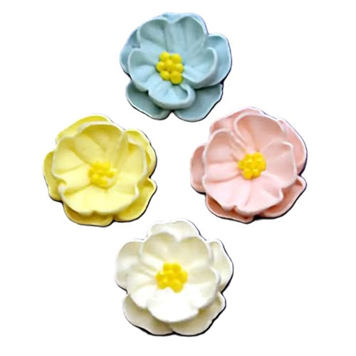 Collection of pastel-colored royal icing flowers in blue, yellow, and pink, with intricate petal shapes and contrasting yellow centers.