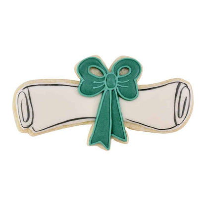 Decorated diploma-shaped cookie with a green bow, perfect for graduation celebrations.