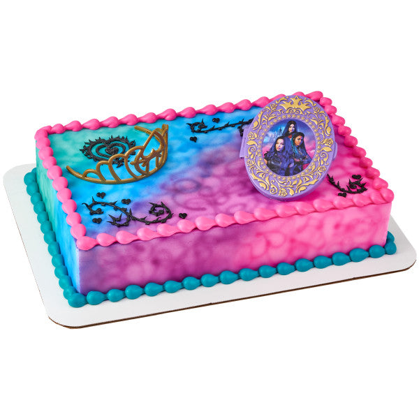 A vibrant pink and blue cake featuring the Descendants locket and tiara topper.