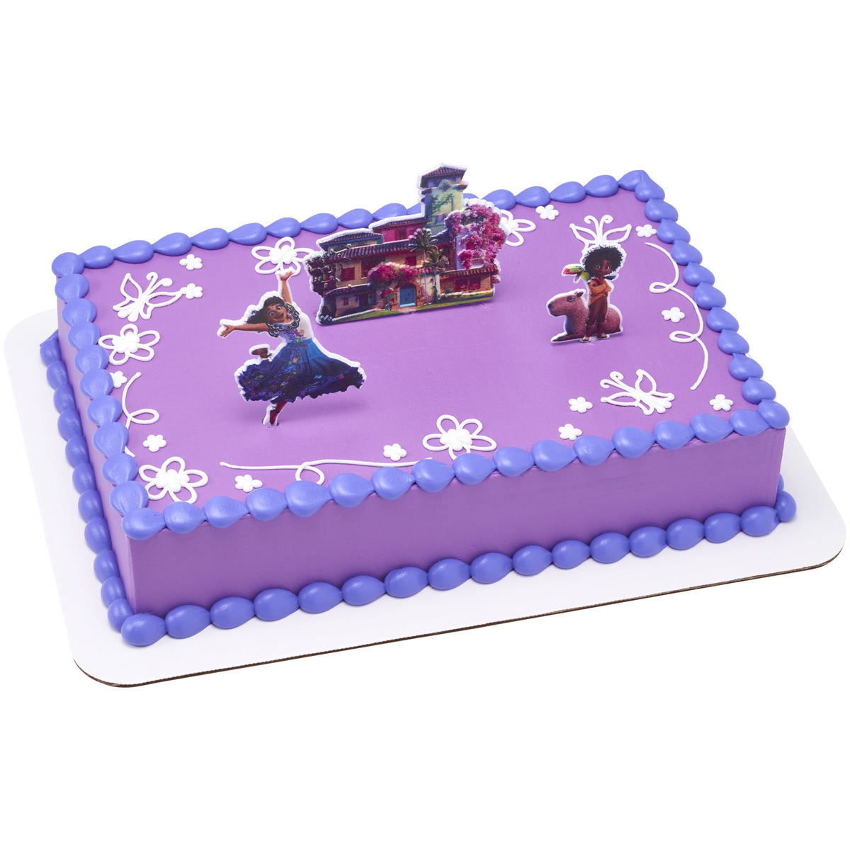 Rectangular purple Disney Encanto cake decorated with Mirabel, Antonio, and the colorful Madrigal house cake picks, plus lavender piping and white floral accents.