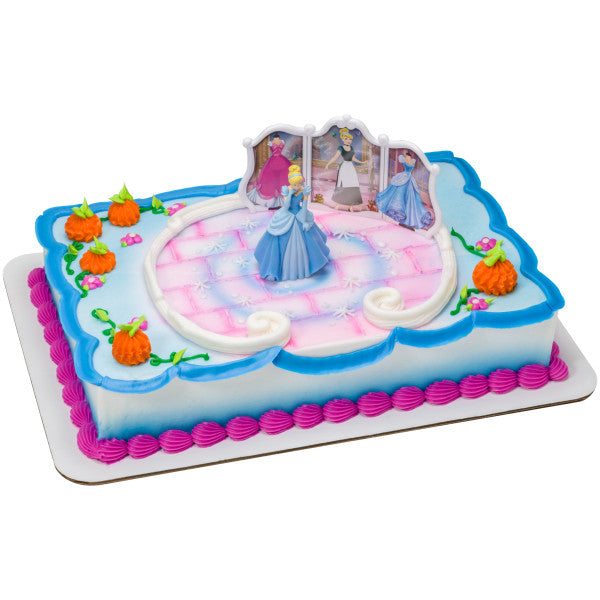 A rectangular cake with a princess-themed design, featuring Cinderella, the backdrop, and pumpkin decorations.