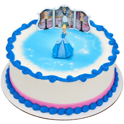 A round cake decorated with sparkling blue icing, topped with Cinderella and the interactive backdrop.