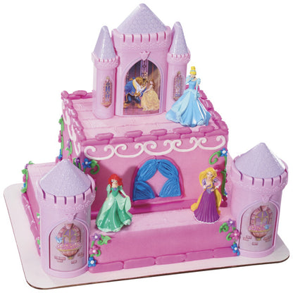 A tiered castle-themed cake decorated with the Disney Princess Castle Signature DecoSet®, creating a magical fairy tale display with princess figurines.