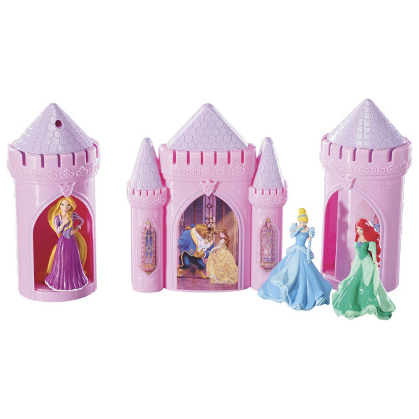 Disney Princess Castle Signature DecoSet® featuring a pink castle with Belle and the Beast, two turrets, and figurines of Ariel, Cinderella, and Rapunzel.