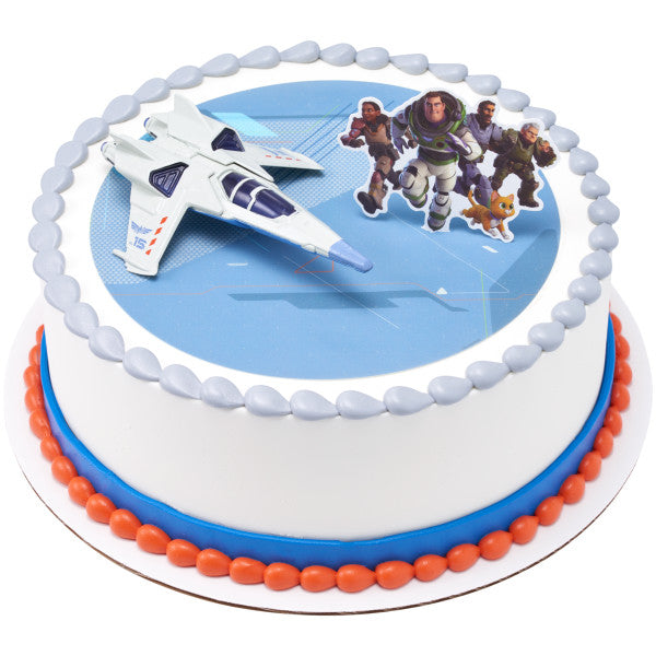 A round cake with blue and white icing, topped with the Lightyear jet and character pick.