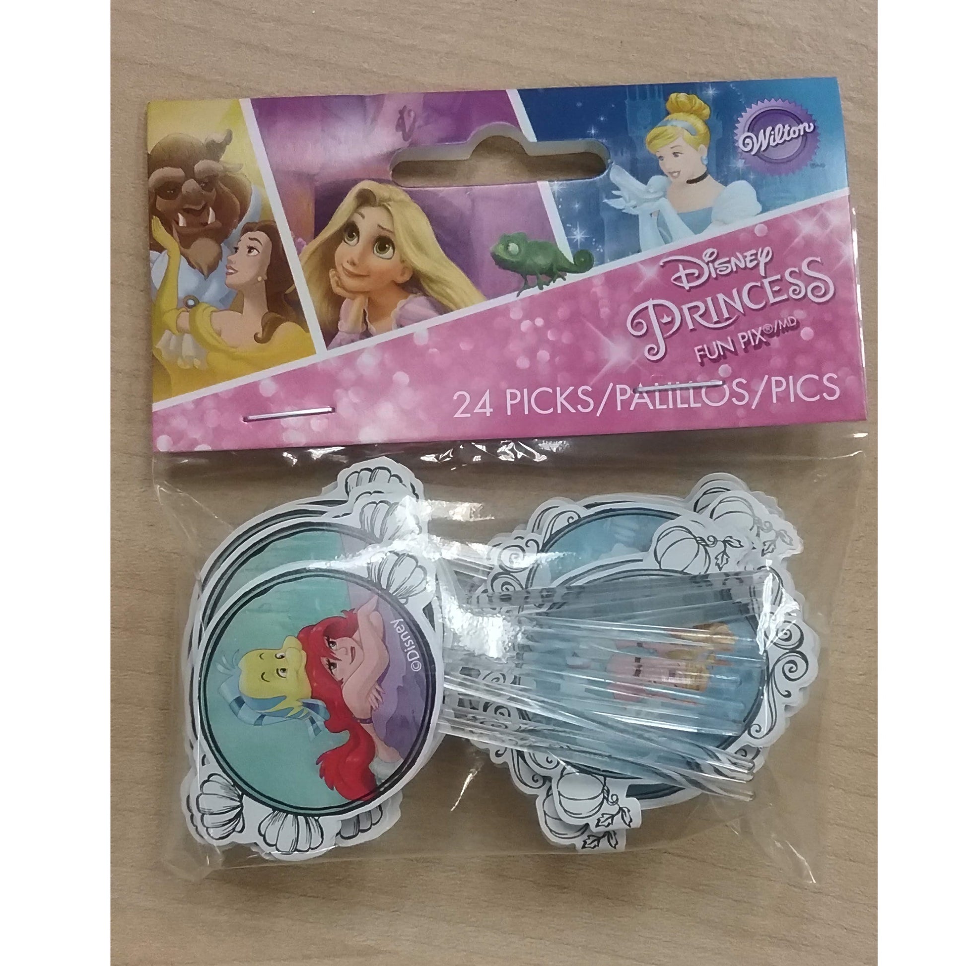 Packaged Disney Princess cupcake picks showing Ariel, Belle, and Rapunzel on the card, with the picks themselves featuring Ariel in a swimming pose.