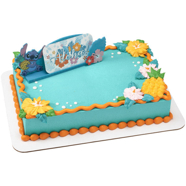 A tropical-themed rectangular cake decorated with bright flowers, featuring the Stitch topper.