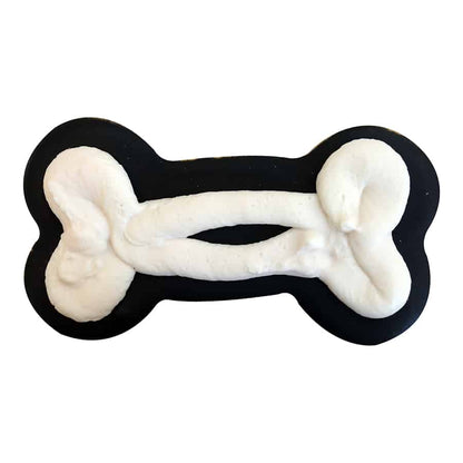 Dog bone-shaped cookie decorated with black icing and fluffy white frosting details.