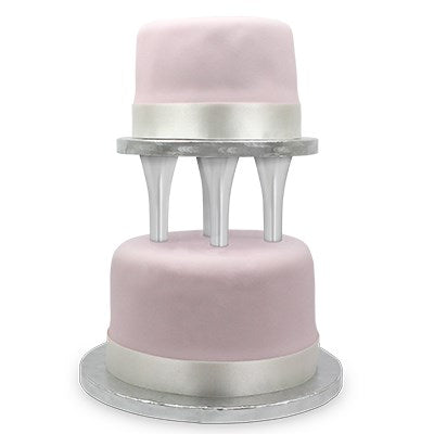 Two-tier cake separated by PME spiked pillars, showing elegant floating tier effect with clean fondant finish.