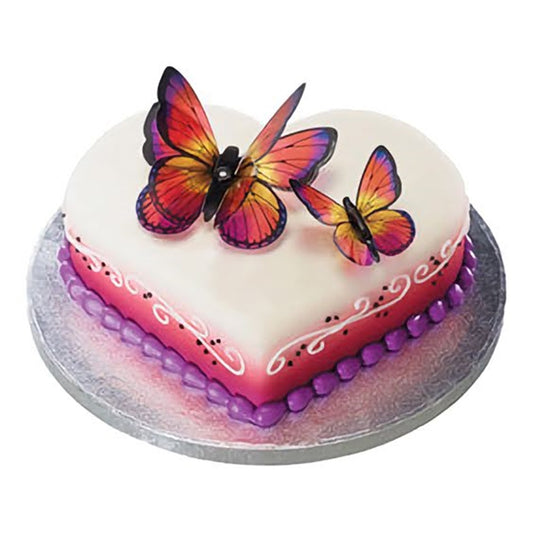 This romantic heart-shaped cake is covered in smooth white fondant and decorated with a gradient of purple to pink around the base. The cake is beautifully embellished with delicate butterflies with wings outstretched, adding an elegant and enchanting touch suitable for anniversaries, Valentine's Day, or garden parties.