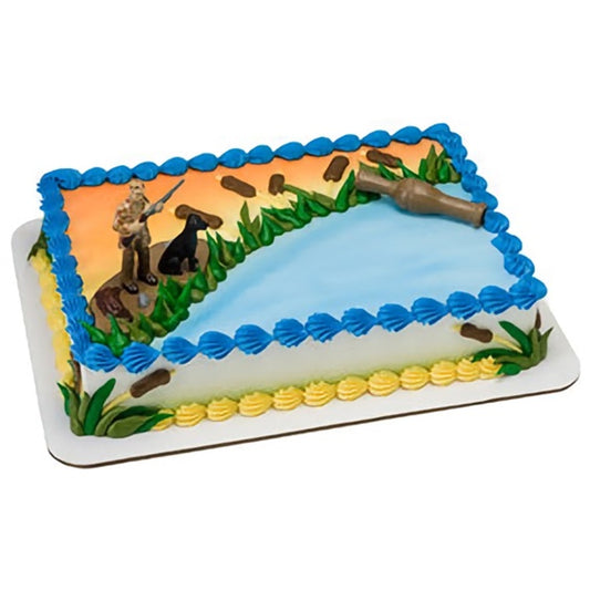 A duck hunting cake topper set featuring hunters with shotguns in a marsh-like setting, with blue water accents and green foliage details, great for outdoor enthusiasts and celebratory events with a hunting theme.