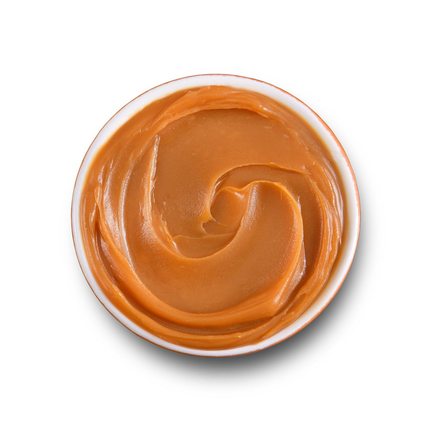 Top-down view of a white bowl filled with glossy dulce de leche milk caramel, swirled into a smooth spiral with a warm golden-brown color on a white background.