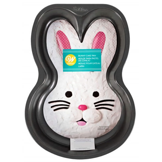 A non-stick baking pan shaped like the face of a bunny, with contoured edges to create detailed facial features once baked. The pan displays a white bunny with pink polka-dotted inner ears, black whiskers, a pink nose, and playful black eyes. A label in the center showcases the product branding, indicating it's for baking bunny-shaped cakes. The pan is designed to bring a festive Easter theme to baked goods.