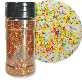 A bottle of rainbow colored edible glitter flakes with a close-up showing their shimmering texture.