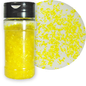 A bottle of yellow edible glitter flakes with a close-up showing their shimmering texture.