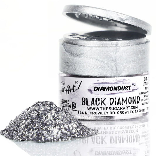 Open jar of DiamondDust Black Diamond edible glitter with a mound of fine black-silver sparkle in front; silver flip-top lid and label visible, showing metallic shimmer.