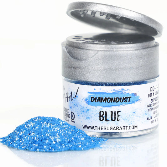 Open jar of DiamondDust Blue edible glitter with a mound of vivid bright-blue sparkle beside it; silver flip-top lid and “BLUE” label visible.