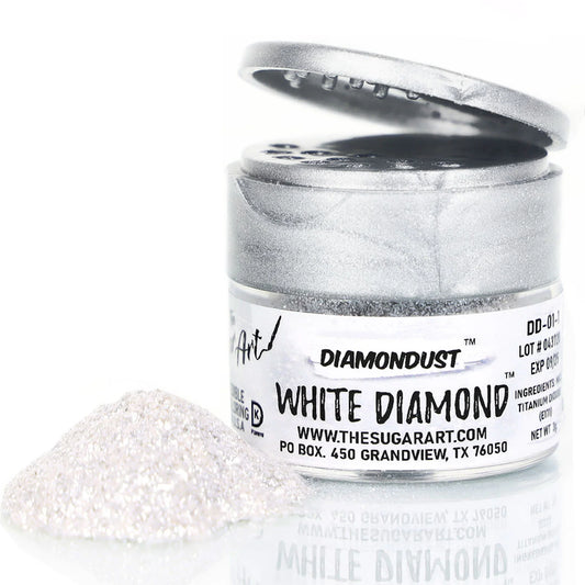 Open jar of DiamondDust White Diamond edible glitter with a metallic silver lid and a small pile of fine, shimmering white sparkles beside it; product label reads “WHITE DIAMOND.”