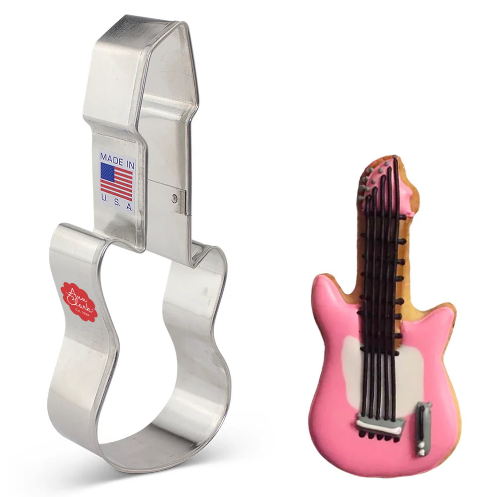 Electric Guitar Cookie Cutter next to a decorated cookie with pink icing, black icing strings, and detailed guitar features.