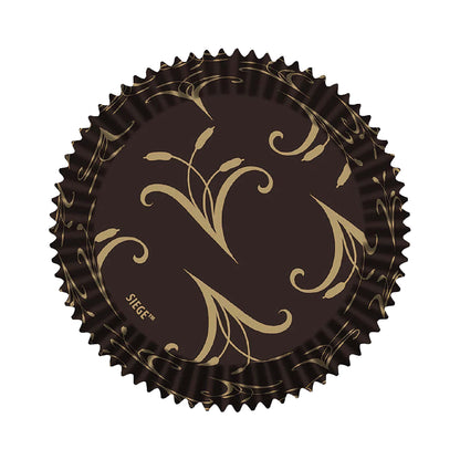 Overhead view of a single jumbo baking cup featuring a gold swirl pattern on dark paper.
