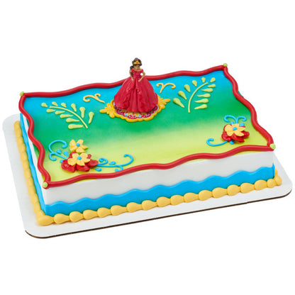 A festive sheet cake with the Elena figurine on a colorful base, decorated with floral and scrollwork designs.