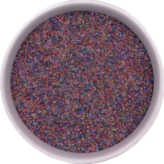 Rainbow colored fine sanding sugar in a clear bag, multicolored crystals perfect for birthday and candy-themed treats.