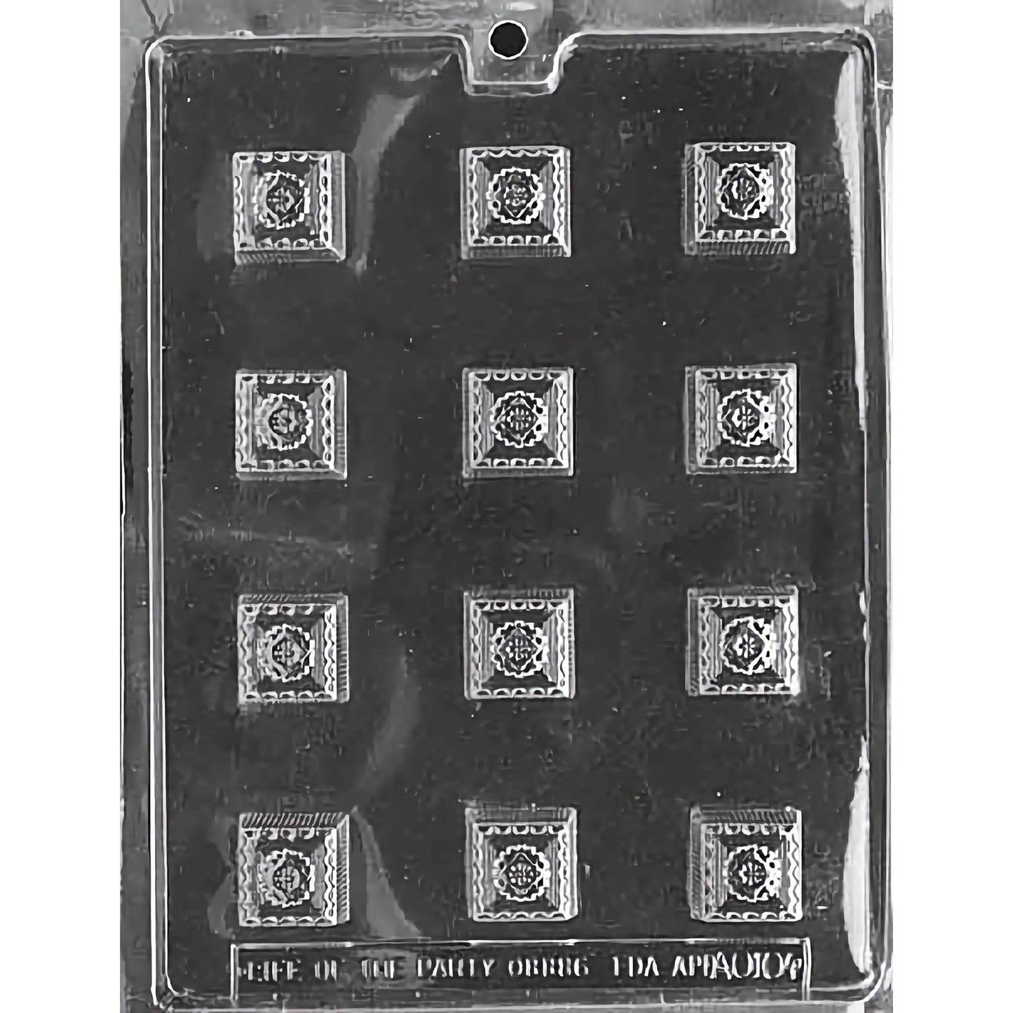 Clear plastic chocolate mold with twelve square cavities, each featuring an ornate design in the center. The mold is displayed against a black background, which highlights the intricate details of the decorative pattern within each square cavity. Ideal for creating elegant, bite-sized chocolate pieces.