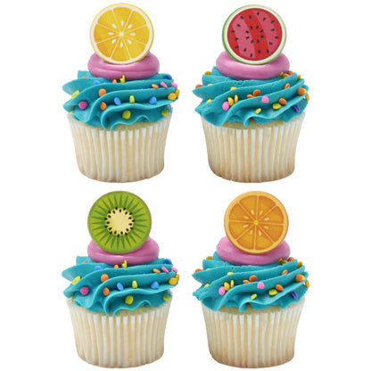 Four cupcakes topped with fruit slice cupcake rings, featuring lemon, watermelon, kiwi, and orange designs, with blue and pink frosting and rainbow sprinkles.