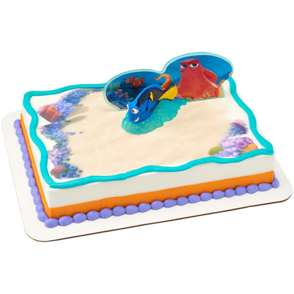 A sheet cake decorated with ocean colors, featuring the Finding Dory cake topper set with Dory positioned on a blue base.