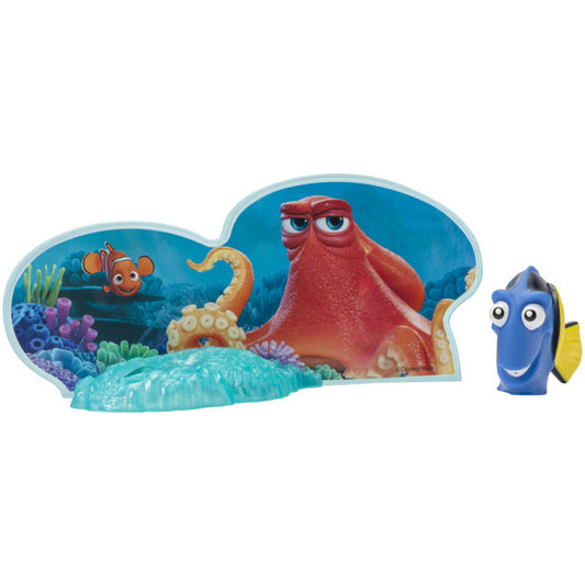 A Dory figurine that squirts water alongside a colorful plastic layon featuring Hank the octopus and Nemo in an underwater scene.