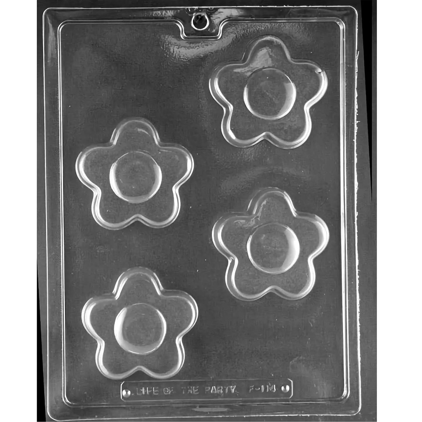 Clear plastic chocolate mold photographed on a black background with four large flower-shaped cavities, each showing rounded petals and a raised circular center.