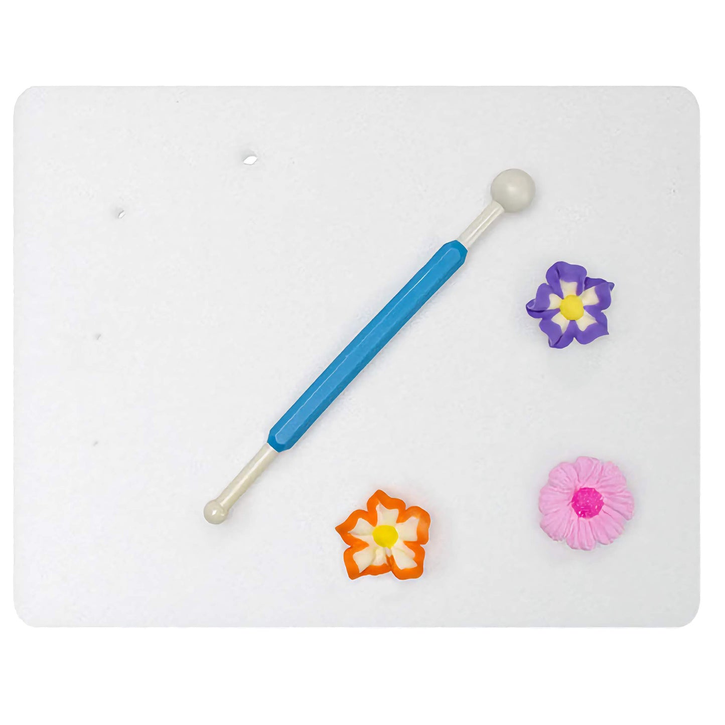 Ateco foam modeling pad with a blue-handled ball tool and colorful sugar paste flowers, ideal for shaping and detailing decorations