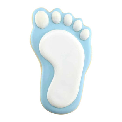 Baby footprint-shaped sugar cookie decorated with smooth blue and white icing, designed for a baby shower.