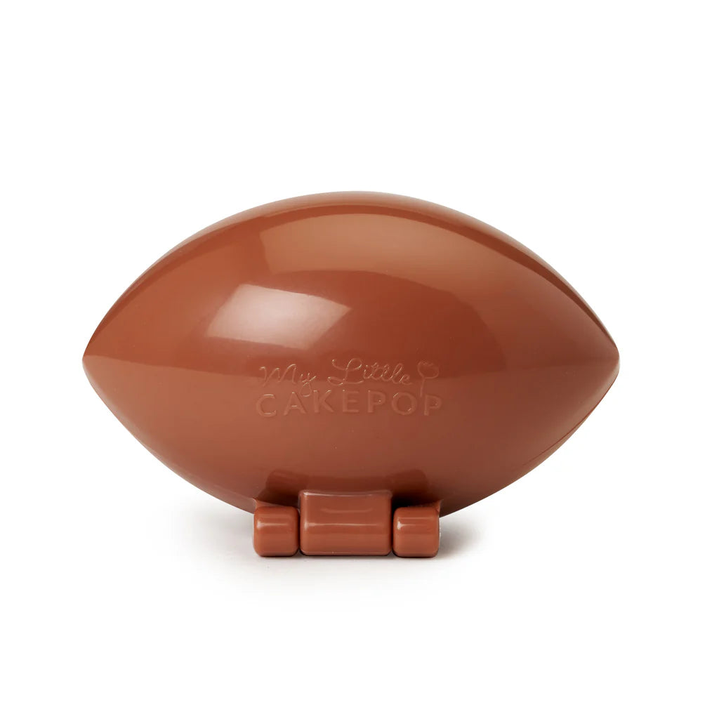 Brown football-shaped My Little Cakepop cake pop mold with a glossy finish, hinged two-piece design, and embossed logo, displayed closed on a white background.