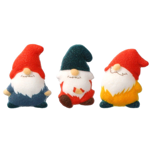 Three pressed sugar gnome decorations with white beards and closed eyes, featuring red and teal pointed hats and blue, red, and yellow outfits on a white background.