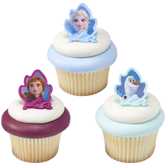 Enchanting cupcake toppers from 'Frozen II' with Elsa, Anna, and Olaf, capturing the magic of the movie in edible form, perfect for a Frozen-themed party.