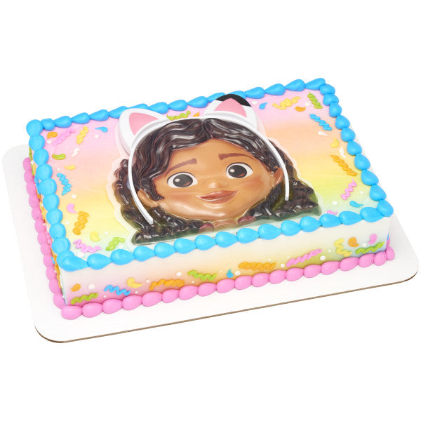 Rectangular cake decorated with a Gabby’s Dollhouse topper, colorful icing, and confetti details.