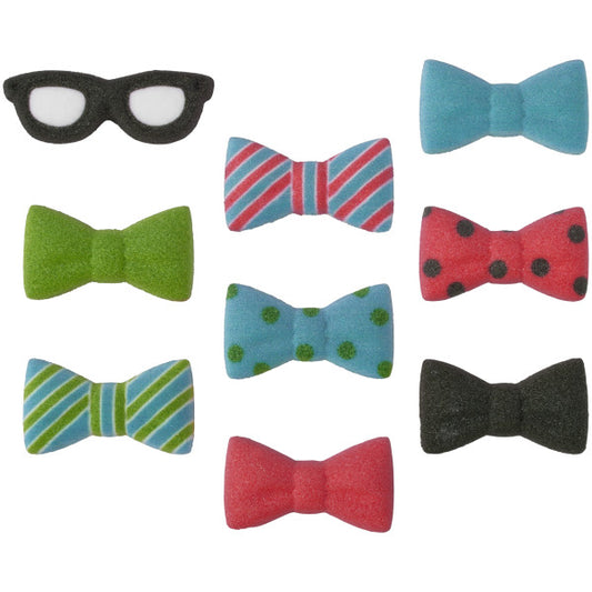 Assortment of pressed sugar decorations including colorful bow ties and one pair of black glasses for decorating desserts.