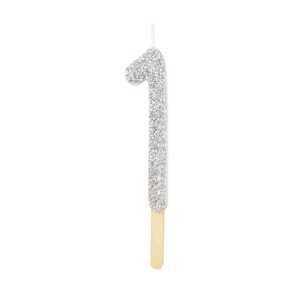 Silver glitter number 1 candle with attached pick, ideal for cakes and celebration decor.