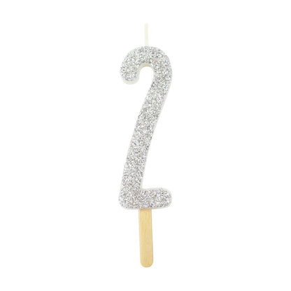 Silver glitter number 2 candle with attached pick, ideal for cakes and celebration decor.