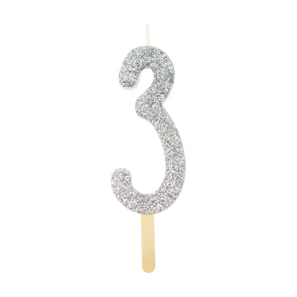 Silver glitter number 3 candle with attached pick, ideal for cakes and celebration decor.