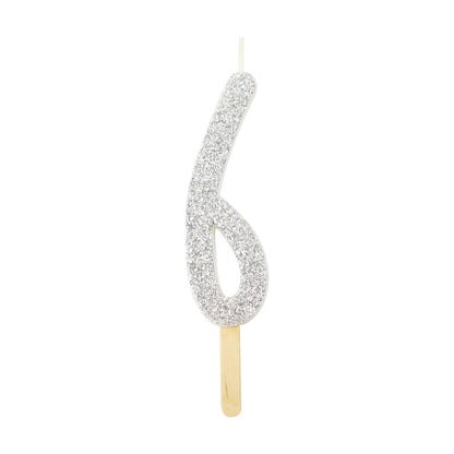 Silver glitter number 6 candle with attached pick, ideal for cakes and celebration decor.