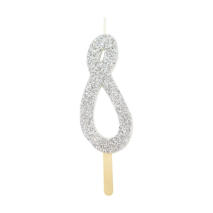 Silver glitter number 8 candle with attached pick, ideal for cakes and celebration decor.