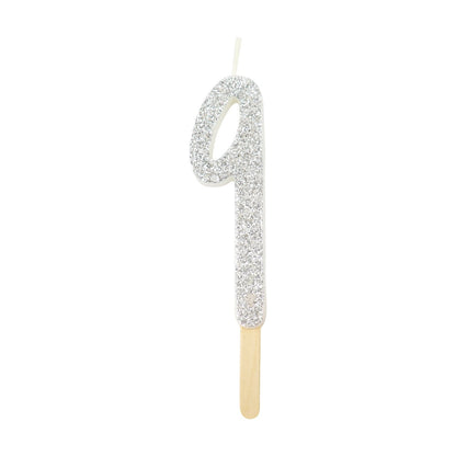 Silver glitter number 9 candle with attached pick, ideal for cakes and celebration decor.