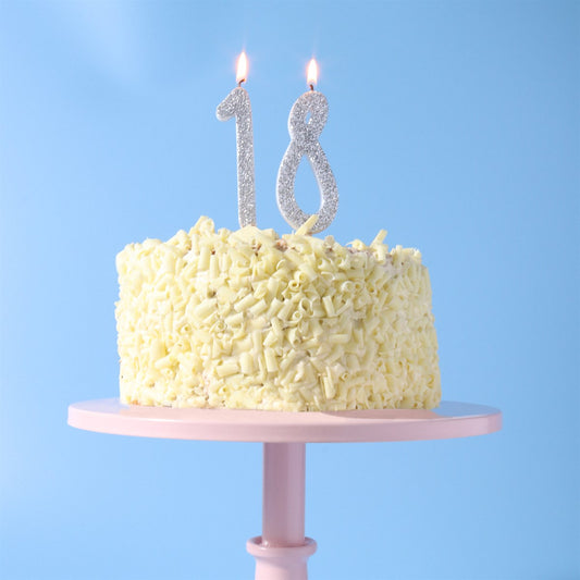 Silver glitter number 1 and number 8 candles in 18th birthday cake.