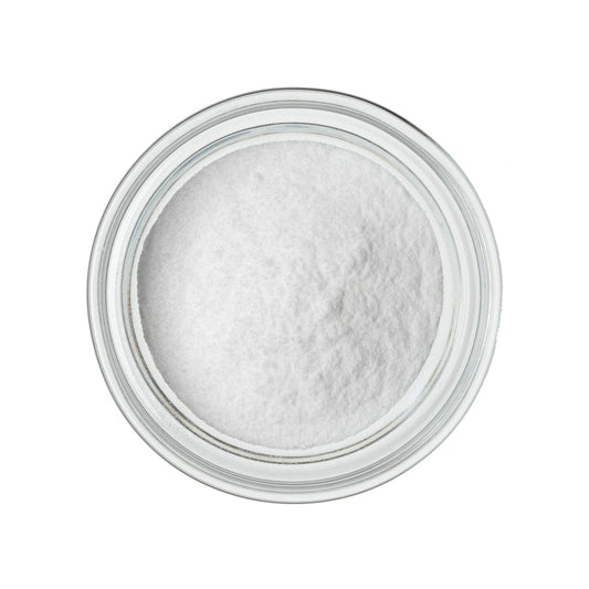 White glucose powder in a round, clear glass bowl, viewed from above on a white background.