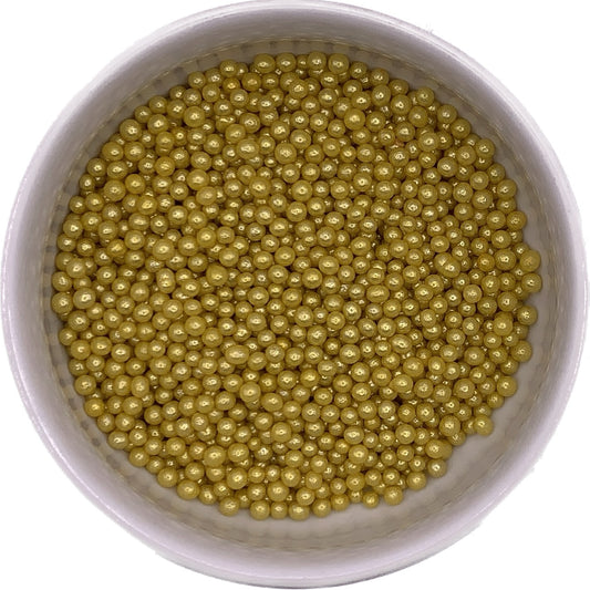 Overhead view of 4mm gold dragees in a white container, used as non-edible decorative accents for cakes and confections.