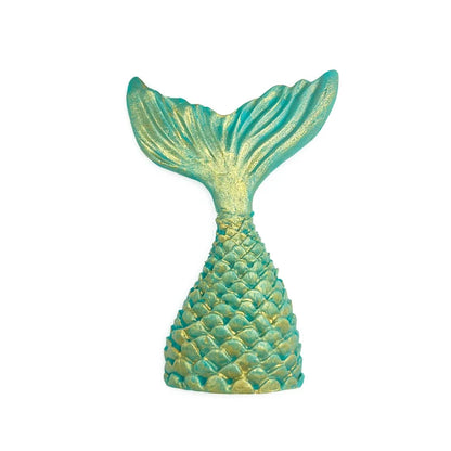 Teal mermaid tail decoration with textured scales and fin ridges highlighted with shimmering gold edible luster dust against a white background.