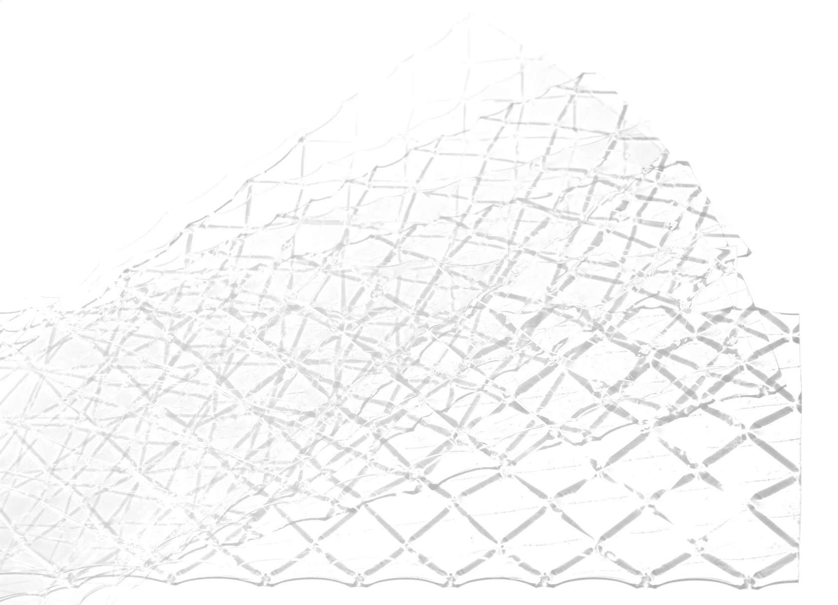 Clear gold leaf gelatine sheets with a faint grid pattern, shown wrinkled and overlapping on a white background.