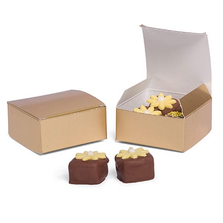 Two small metallic gold folding candy boxes, one open showing flower-topped chocolates, square shape with tuck-top lid; wedding favor packaging.